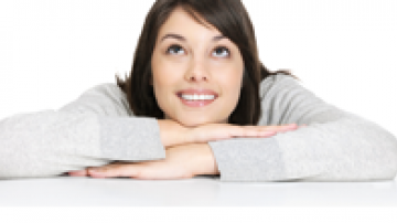 Woman resting her crossed arms and head on a table