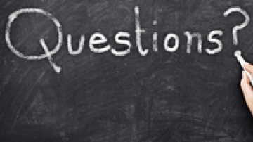 The word Questions written on a chalk board
